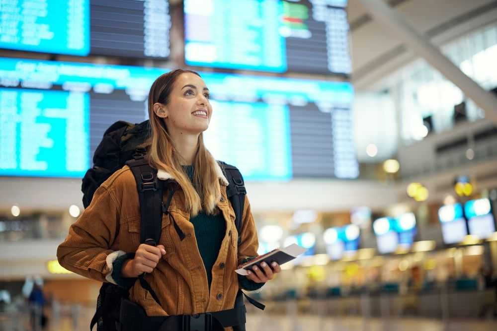 Woman at the airport with a passport in her hand